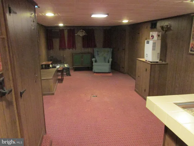 a kitchen with refrigerator and chairs