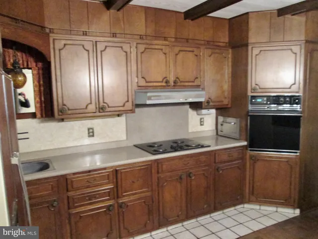 a kitchen with granite countertop stainless steel appliances and wooden cabinets