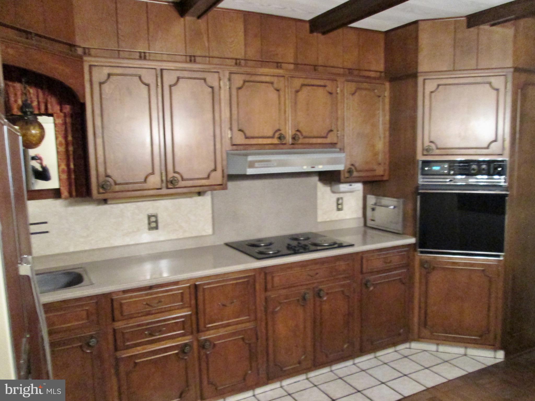1043 Walnut Street Reading, PA 19601 - Photo 2 of 32 a kitchen with granite countertop stainless steel appliances and wooden cabinets
