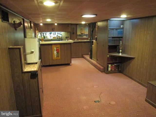 a kitchen with refrigerator and mirror