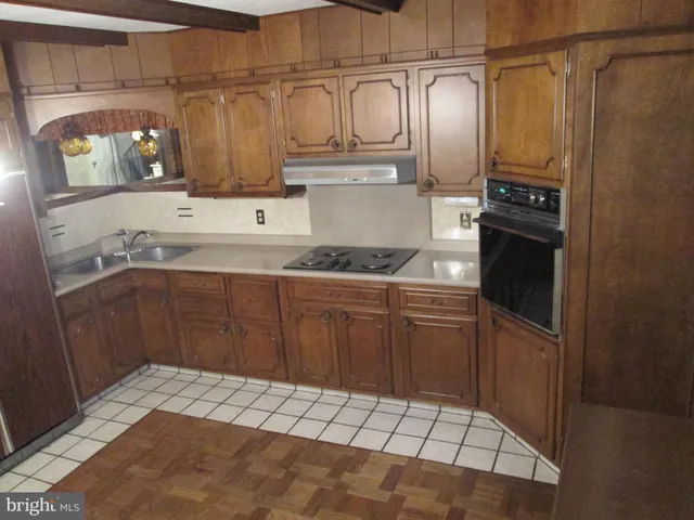 a kitchen with a refrigerator and a sink