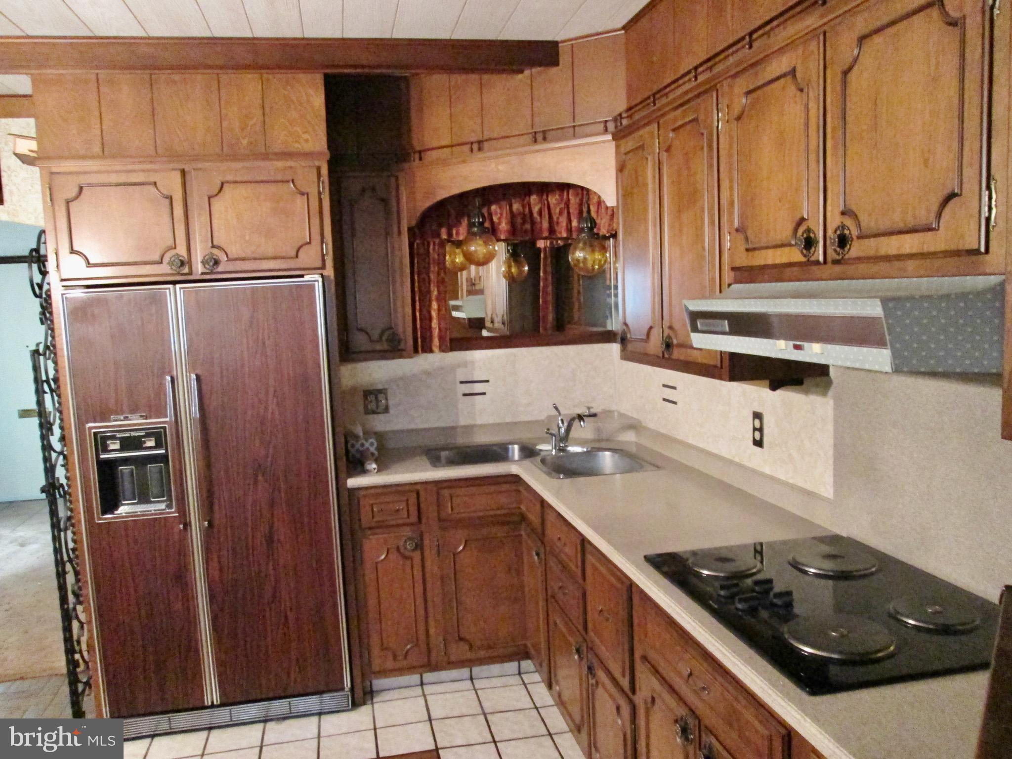 1043 Walnut Street Reading, PA 19601 - Photo 5 of 32 a kitchen with stainless steel appliances granite countertop a sink stove and refrigerator