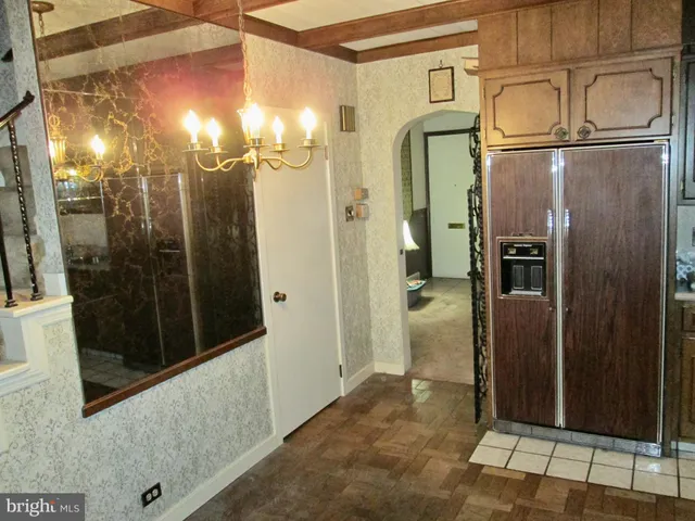 a bathroom with a glass shower door and mirror