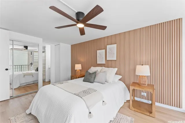 a bedroom with a large bed and a chandelier