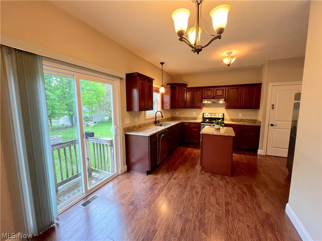 1134 Mayfield Ridge Road Cleveland, OH 44124 - Photo 11 of 41 Kitchen with dark hardwood / wood-style flooring, stainless steel range with electric stovetop, a healthy amount of sunlight, and sink