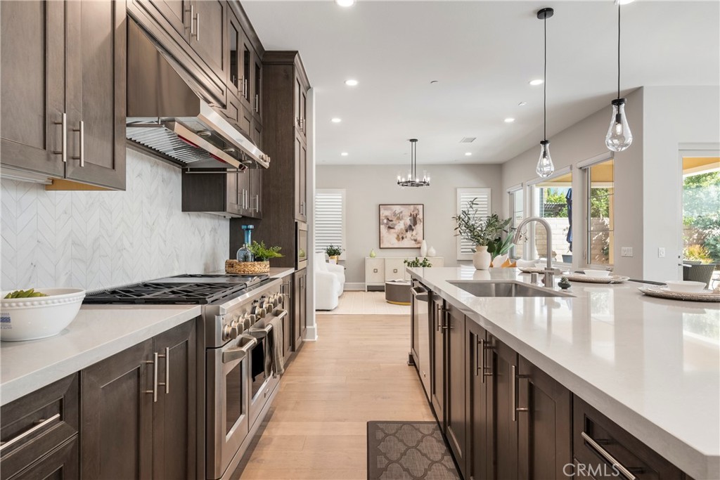 84 Rockinghorse Irvine, CA 92602 - Photo 24 of 63 a kitchen with kitchen island a sink stove and cabinets