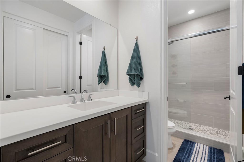 84 Rockinghorse Irvine, CA 92602 - Photo 28 of 63 a bathroom with a double vanity sink a toilet and a shower