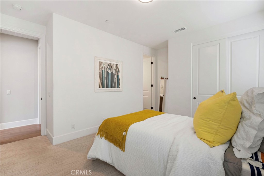 84 Rockinghorse Irvine, CA 92602 - Photo 46 of 63 a bedroom with a bed and a painting on the wall