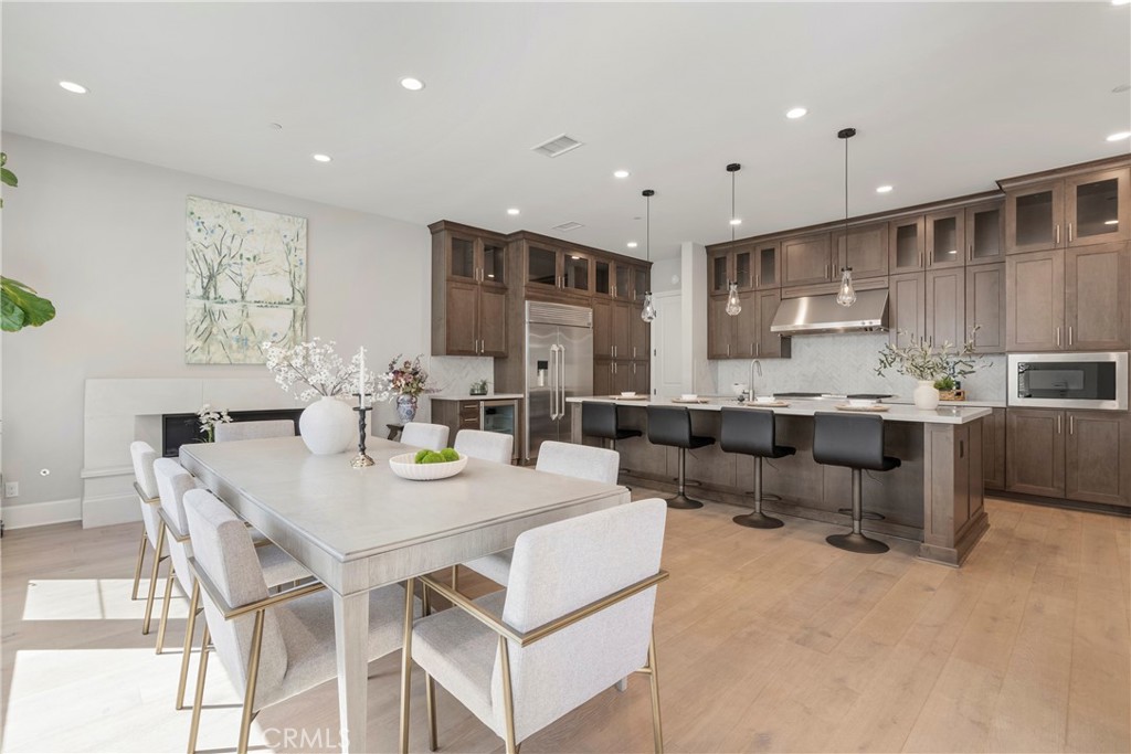 84 Rockinghorse Irvine, CA 92602 - Photo 8 of 63 a view of kitchen with stainless steel appliances kitchen island granite countertop a table and chairs