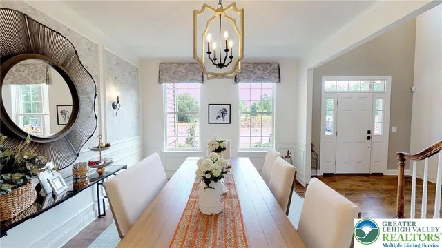 a view of a dining room with furniture and chandelier