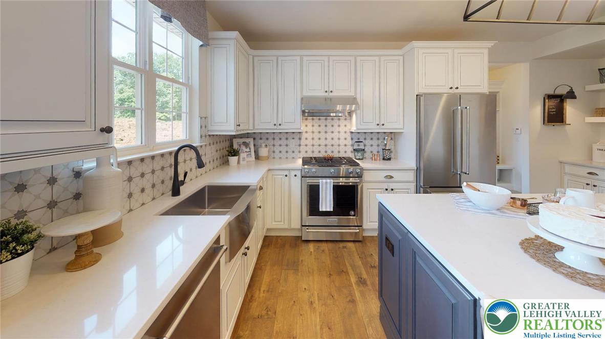 5137 Schantz Road, Unit THE ROOSEVELT Allentown, PA 18104 - Photo 22 of 39 a kitchen with stainless steel appliances granite countertop a sink stove and refrigerator