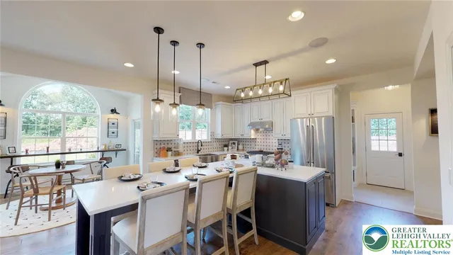 a large kitchen with a large window and stainless steel appliances