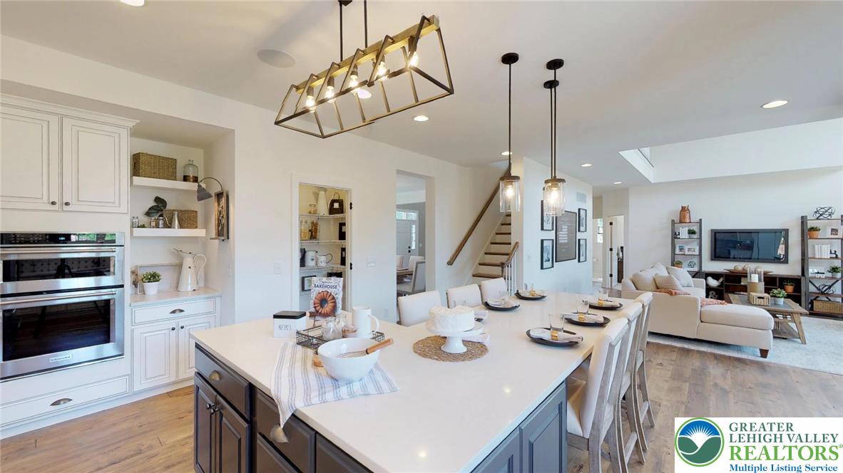 5137 Schantz Road, Unit THE ROOSEVELT Allentown, PA 18104 - Photo 24 of 39 a view of a dining room with furniture a chandelier and wooden floor