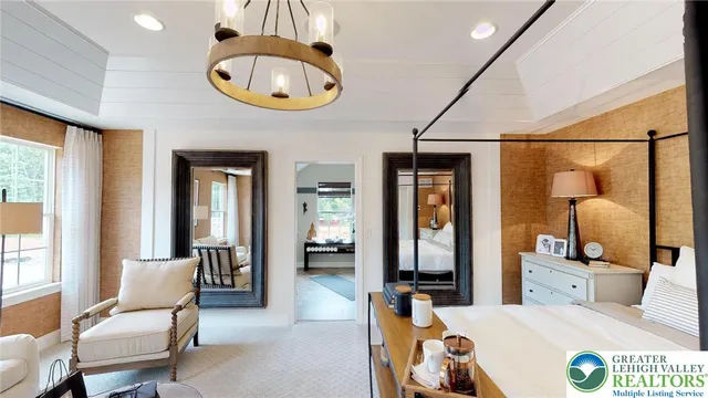 a bedroom with furniture and a chandelier