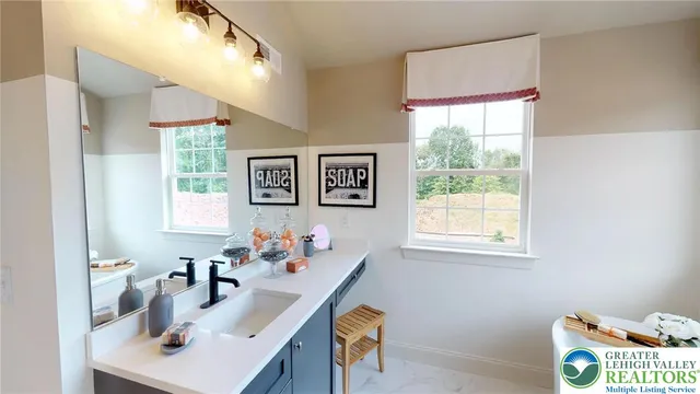 a bathroom with a sink and mirror with toilet