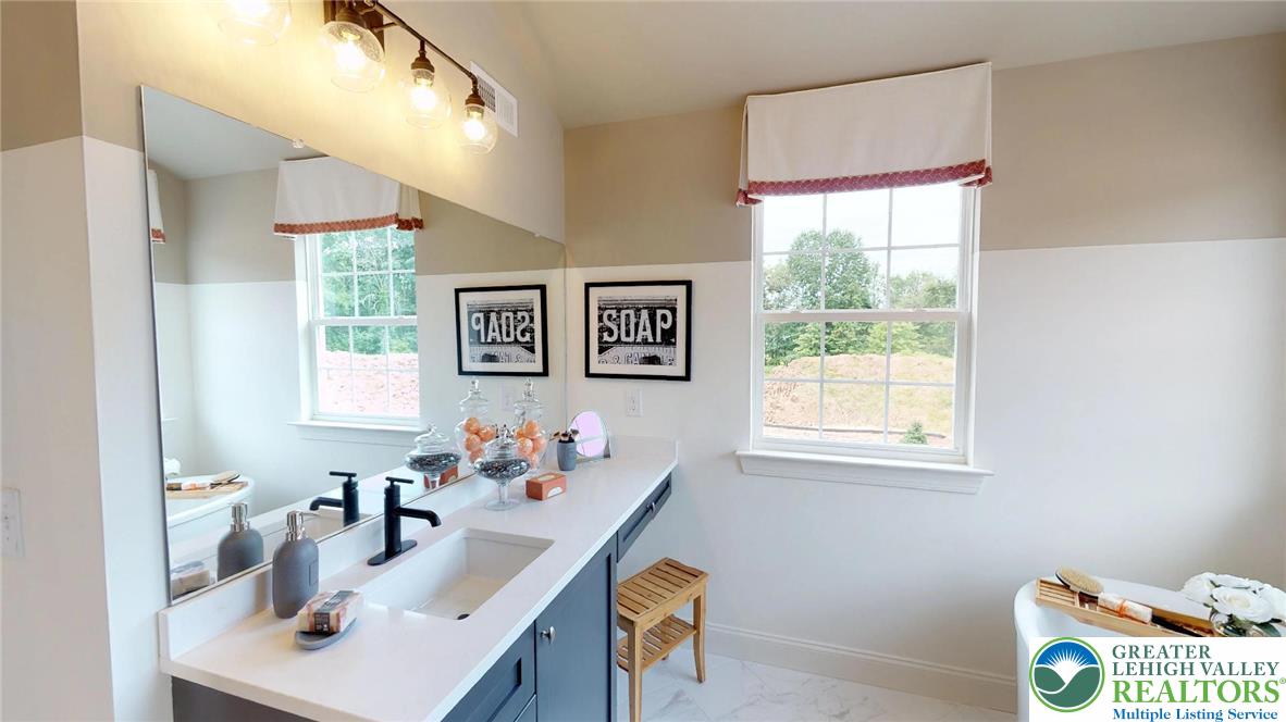 5137 Schantz Road, Unit THE ROOSEVELT Allentown, PA 18104 - Photo 31 of 39 a bathroom with a sink mirror and a window