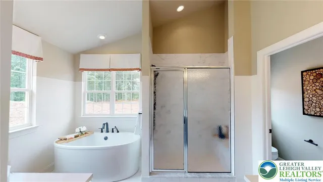 a bedroom with furniture and a large window