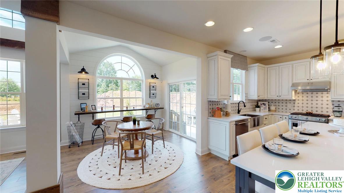 5137 Schantz Road, Unit THE ROOSEVELT Allentown, PA 18104 - Photo 36 of 39 a kitchen with a dining table chairs and window