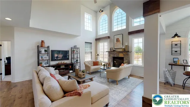 a dining room with wooden floor a chandelier a wooden table and chairs