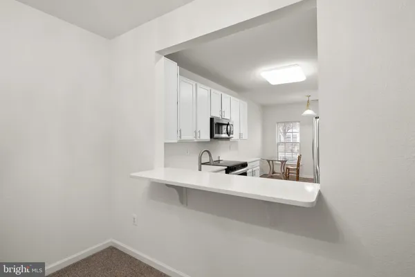 a large white room with a sink