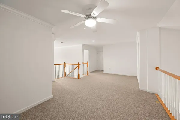a view of a livingroom with a ceiling fan and window
