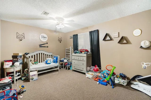 a bedroom with toys and a wooden floor