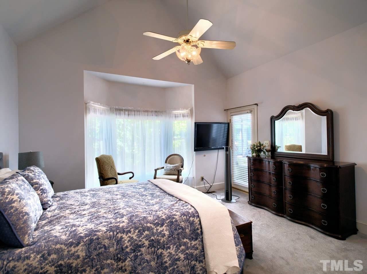 7901 Sandy Bottom Way Raleigh, NC 27613 - Photo 11 of 28 a bedroom with a large bed and a tv