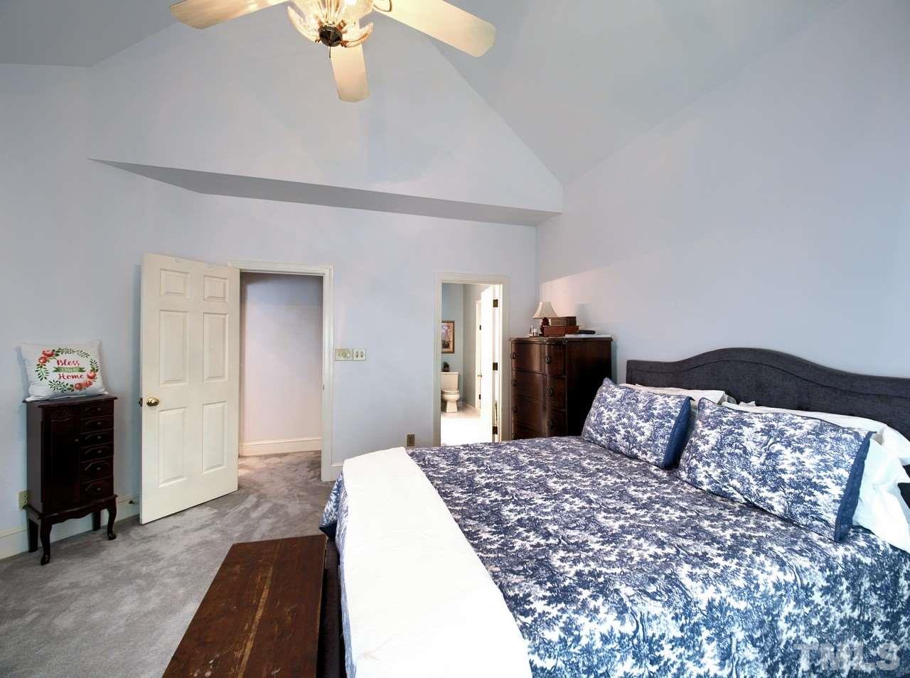 7901 Sandy Bottom Way Raleigh, NC 27613 - Photo 12 of 28 a bedroom with a large bed and dresser