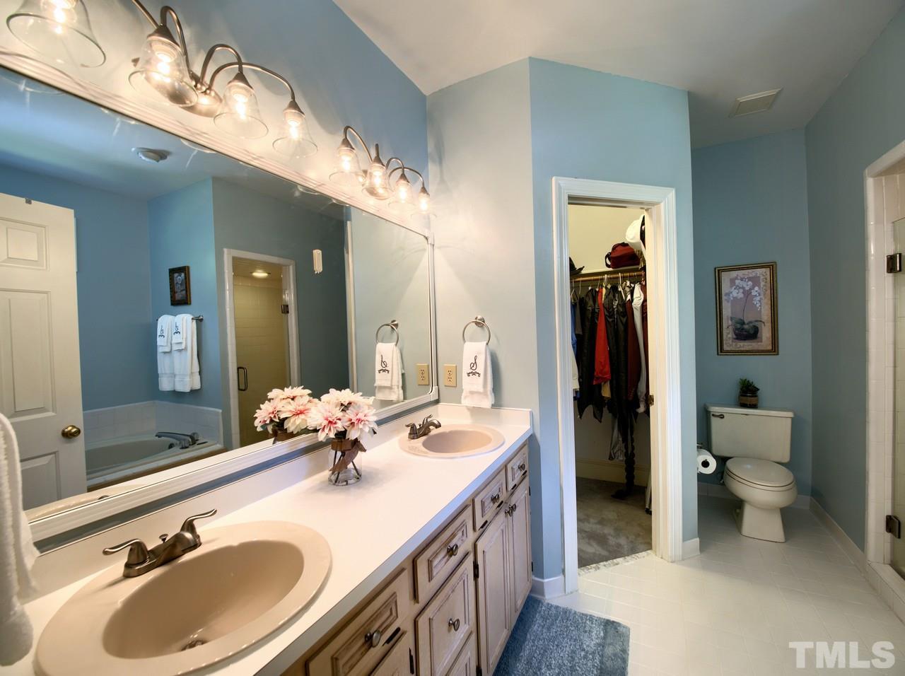 7901 Sandy Bottom Way Raleigh, NC 27613 - Photo 13 of 28 a bathroom with a sink double vanity and a mirror