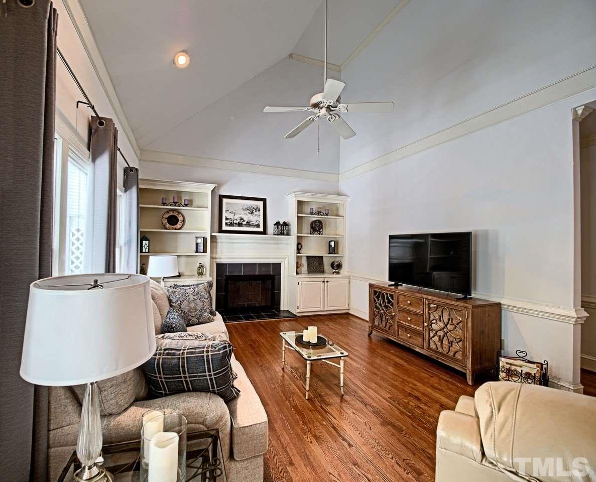 7901 Sandy Bottom Way Raleigh, NC 27613 - Photo 15 of 28 a living room with furniture a fireplace and a flat screen tv