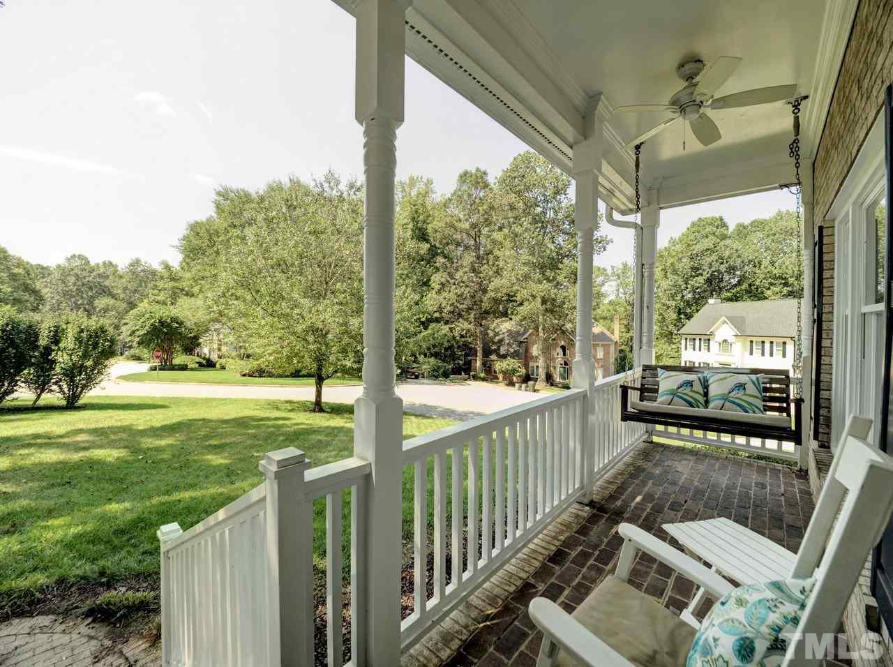 7901 Sandy Bottom Way Raleigh, NC 27613 - Photo 3 of 28 a view of a porch with chairs and backyard