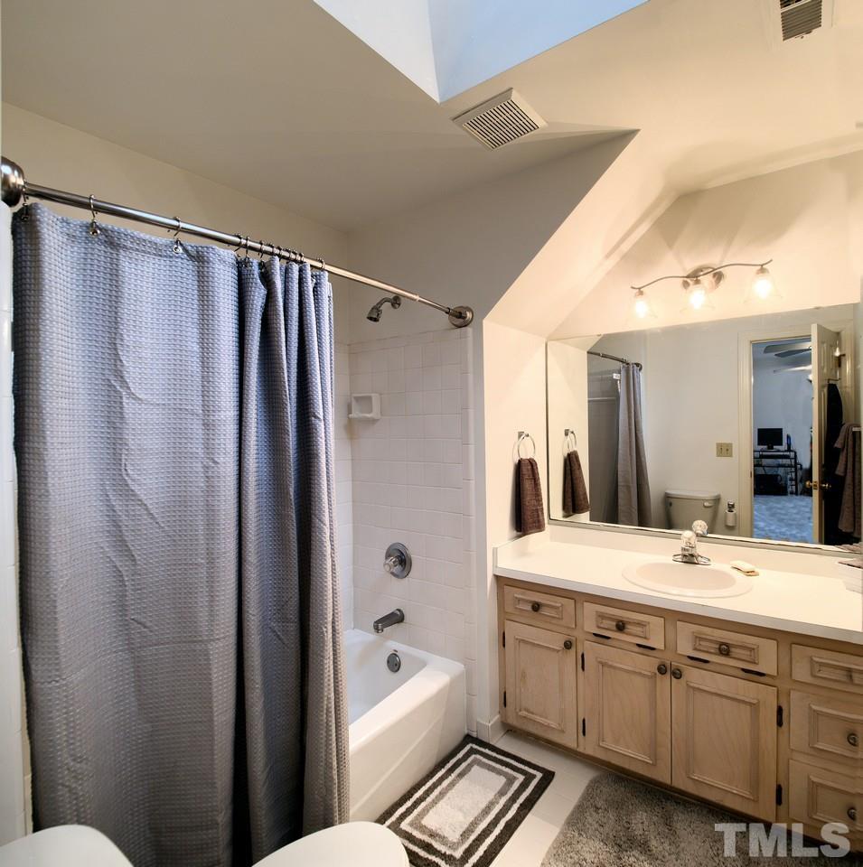 7901 Sandy Bottom Way Raleigh, NC 27613 - Photo 22 of 28 a bathroom with a double vanity sink toilet mirror and shower