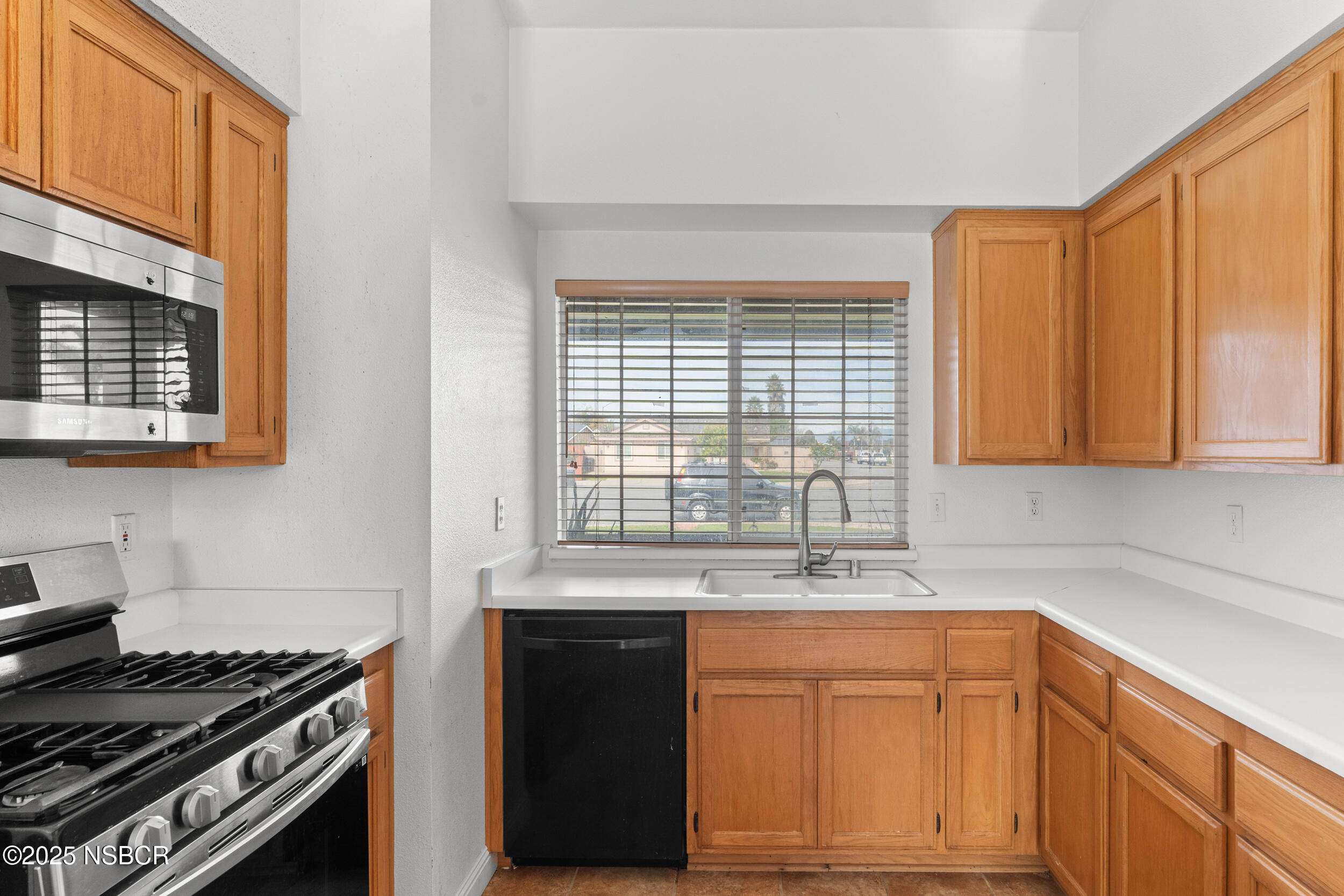 1458 Jacaranda Court Santa Maria, CA 93458 - Photo 11 of 24 a kitchen with stainless steel appliances granite countertop a sink stove and cabinets
