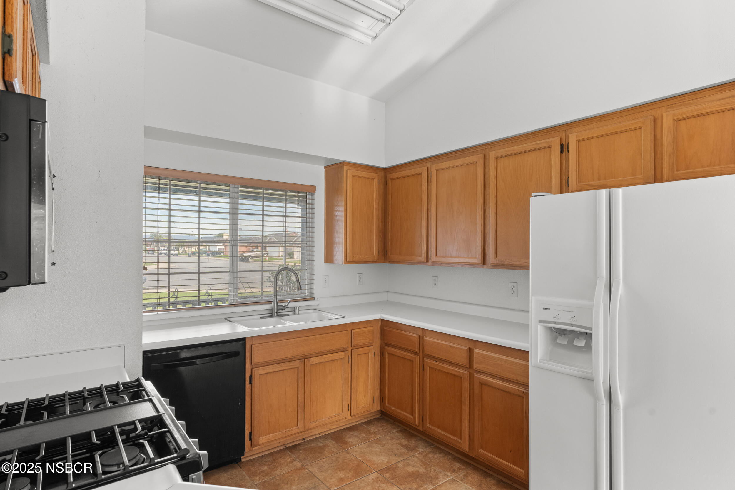 1458 Jacaranda Court Santa Maria, CA 93458 - Photo 12 of 24 a kitchen with a refrigerator stove and sink