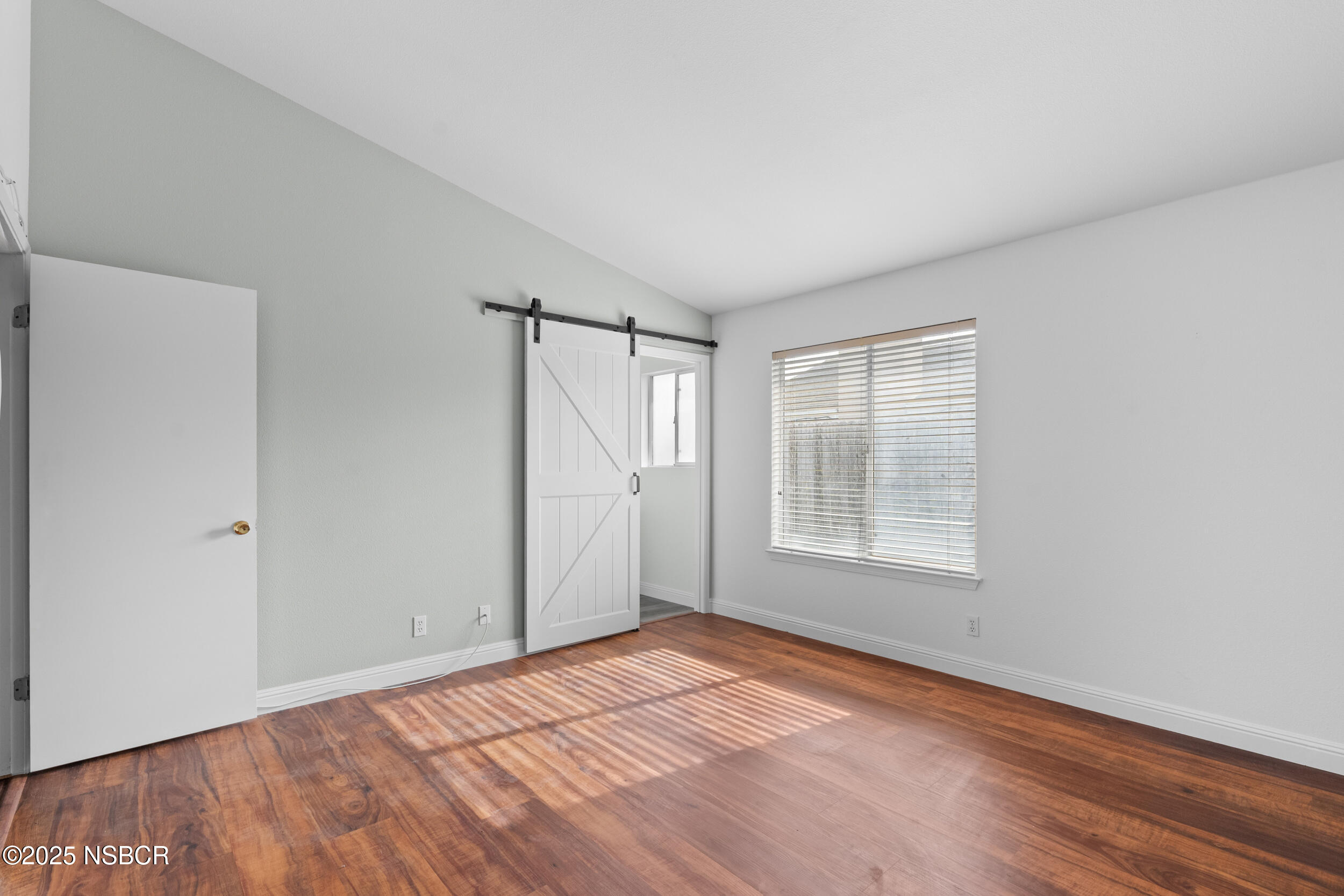 1458 Jacaranda Court Santa Maria, CA 93458 - Photo 15 of 24 a view of an empty room with wooden floor and a window