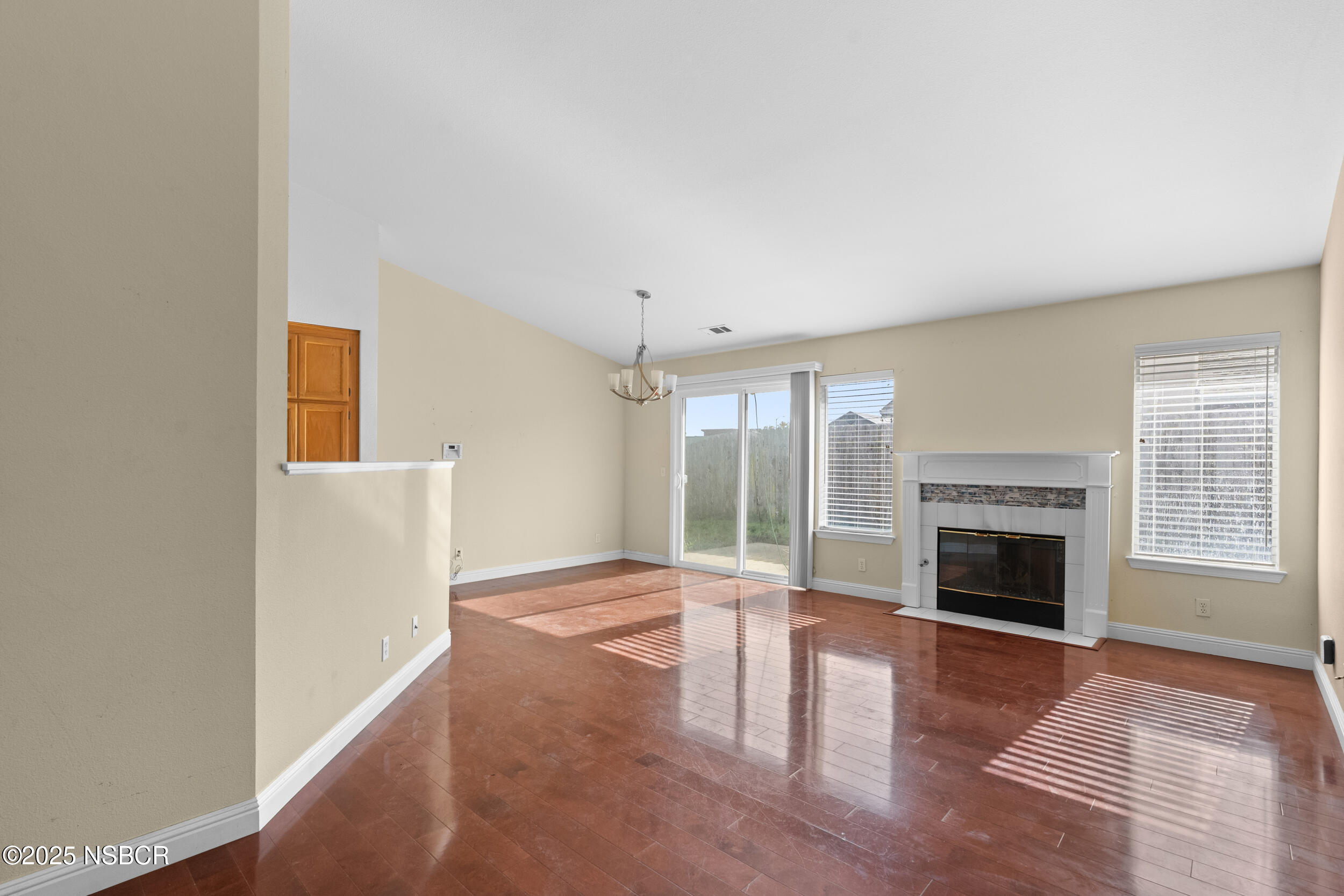 1458 Jacaranda Court Santa Maria, CA 93458 - Photo 3 of 24 a view of an empty room with wooden floor fireplace and a window