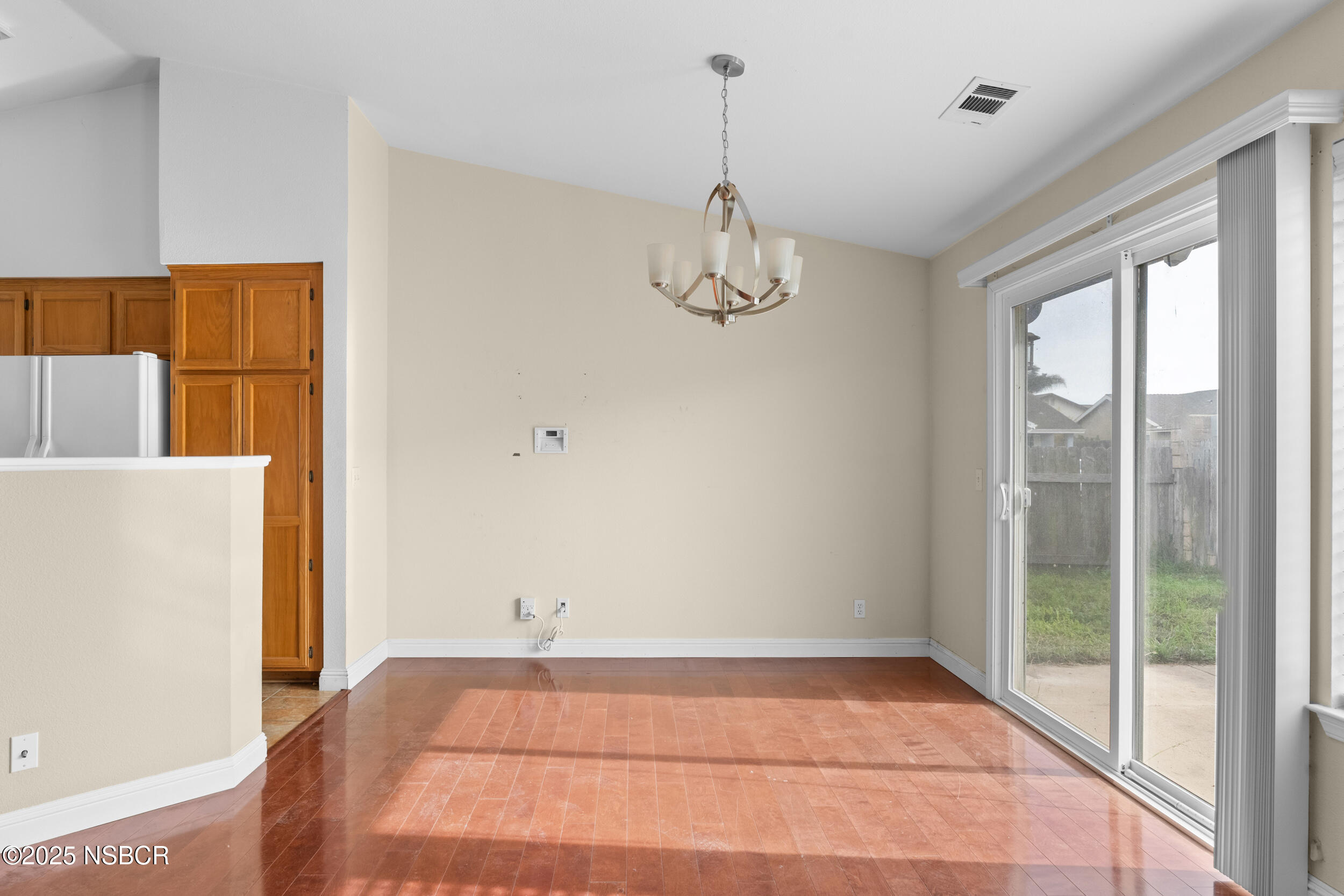1458 Jacaranda Court Santa Maria, CA 93458 - Photo 7 of 24 a view of empty room with wooden floor and fan