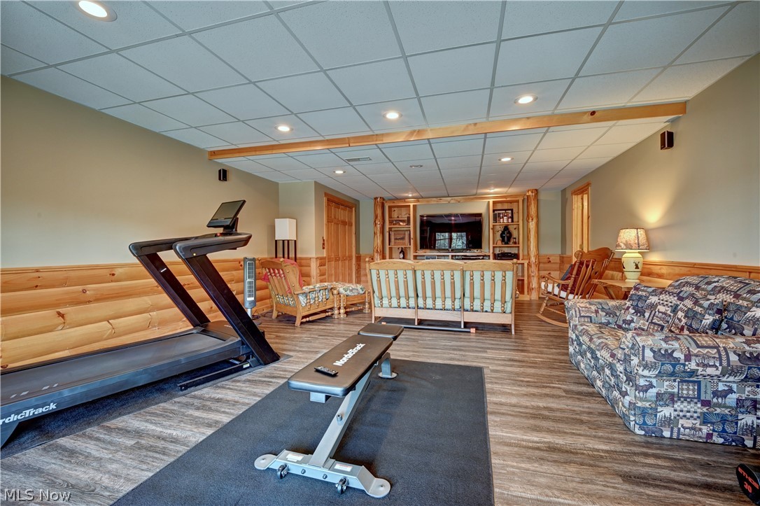 8045 McFadden Road Shreve, OH 44676 - Photo 36 of 45 Exercise area featuring a wainscoted wall, a paneled ceiling, recessed lighting, and wood finished floors