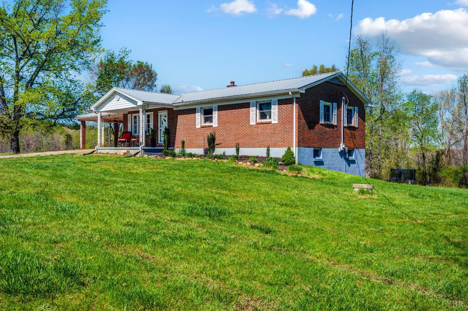 2477 Mountain Road Java, VA 24565 - Photo 3 of 33 a front view of a house with a yard and garage