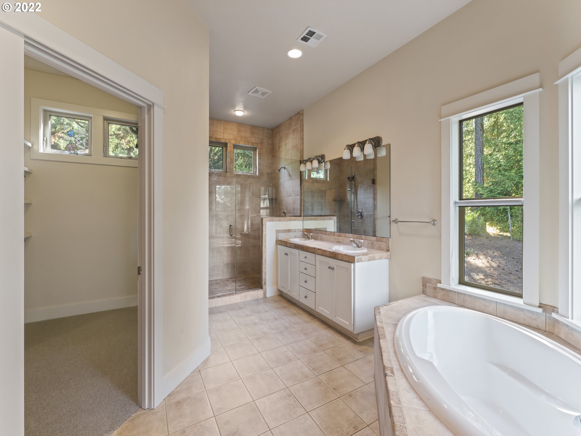 30923 Fox Hollow Road Eugene, OR 97405 - Photo 13 of 31 a large bathroom with a tub sink and mirror