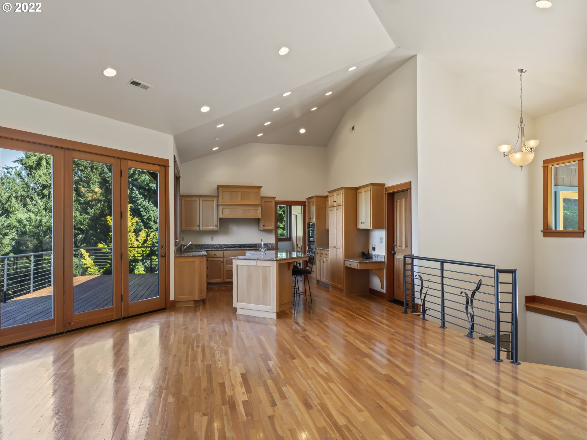 30923 Fox Hollow Road Eugene, OR 97405 - Photo 5 of 31 a open kitchen with stainless steel appliances granite countertop a refrigerator a sink dishwasher a stove and a dining table with wooden floor