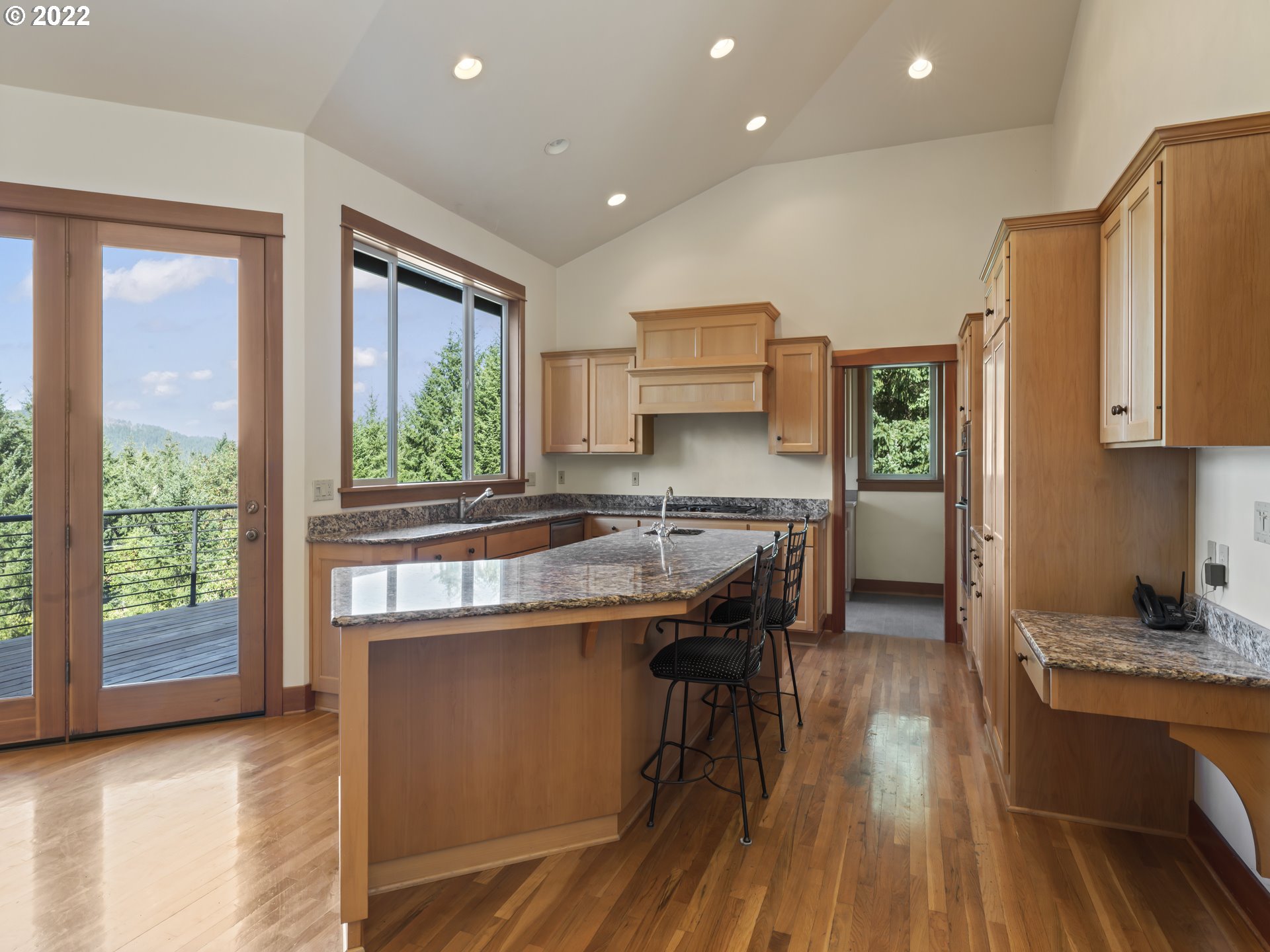 30923 Fox Hollow Road Eugene, OR 97405 - Photo 6 of 31 a kitchen with kitchen island granite countertop a stove a sink and a refrigerator