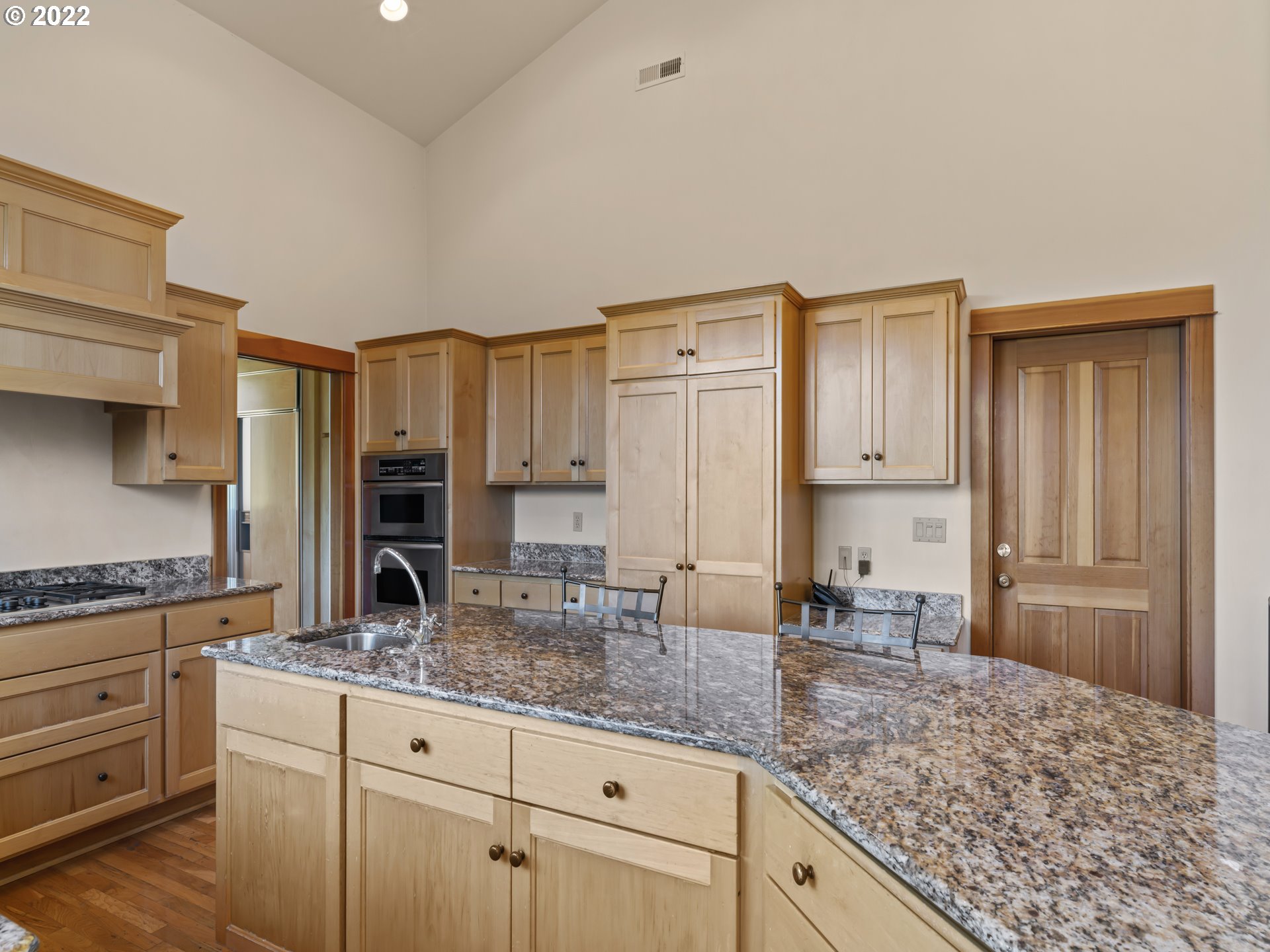 30923 Fox Hollow Road Eugene, OR 97405 - Photo 7 of 31 a kitchen with granite countertop a sink a stove and cabinets