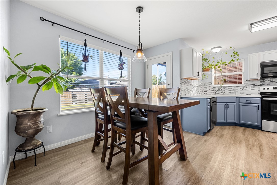 3410 Regency Court Killeen, TX 76549 - Photo 20 of 27 a dining room filled chandelier and wooden floor