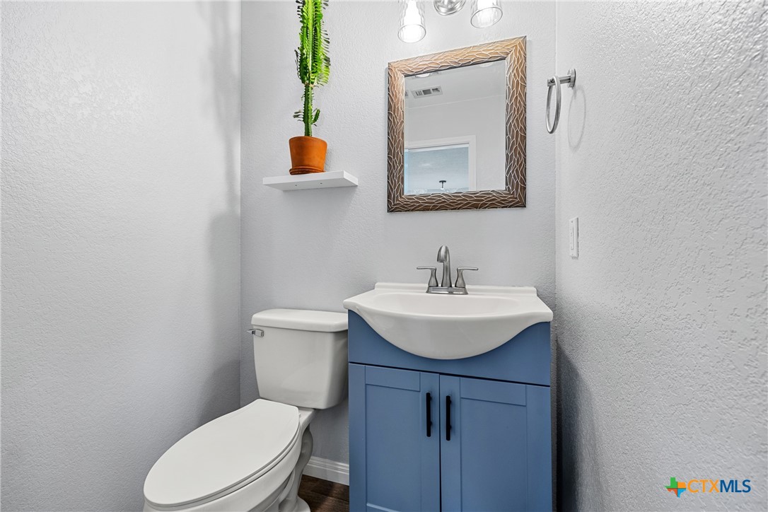 3410 Regency Court Killeen, TX 76549 - Photo 24 of 27 a bathroom with a toilet a sink and mirror