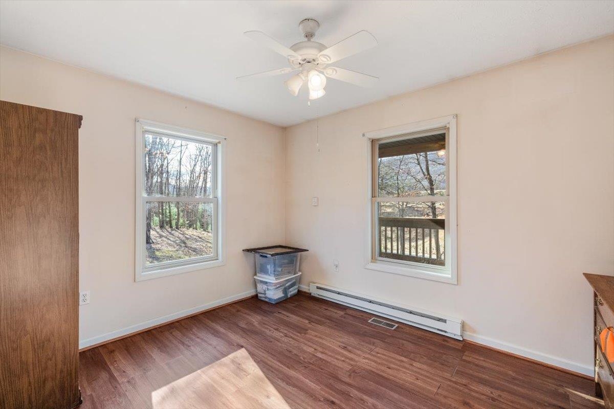 1182 Mullins Road Rio, WV 26755 - Photo 15 of 37 a view of an empty room with a window and wooden floor