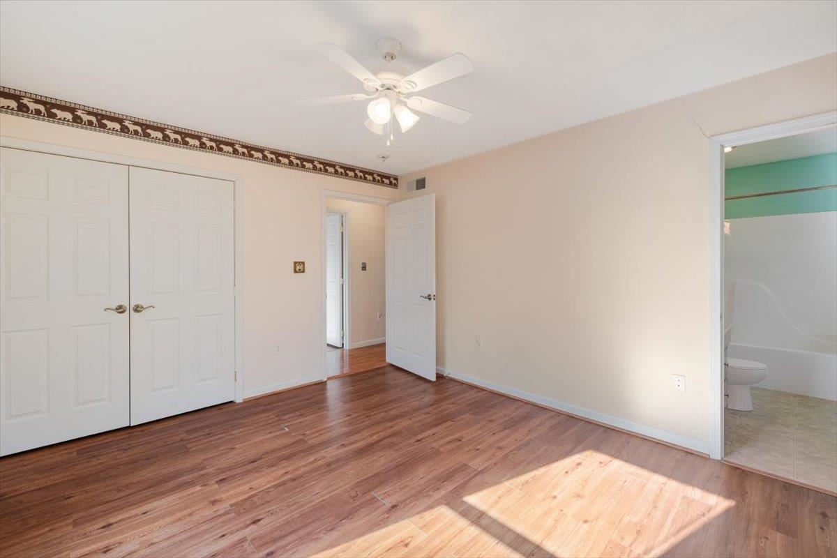 1182 Mullins Road Rio, WV 26755 - Photo 20 of 37 a view of an empty room with wooden floor and a ceiling fan