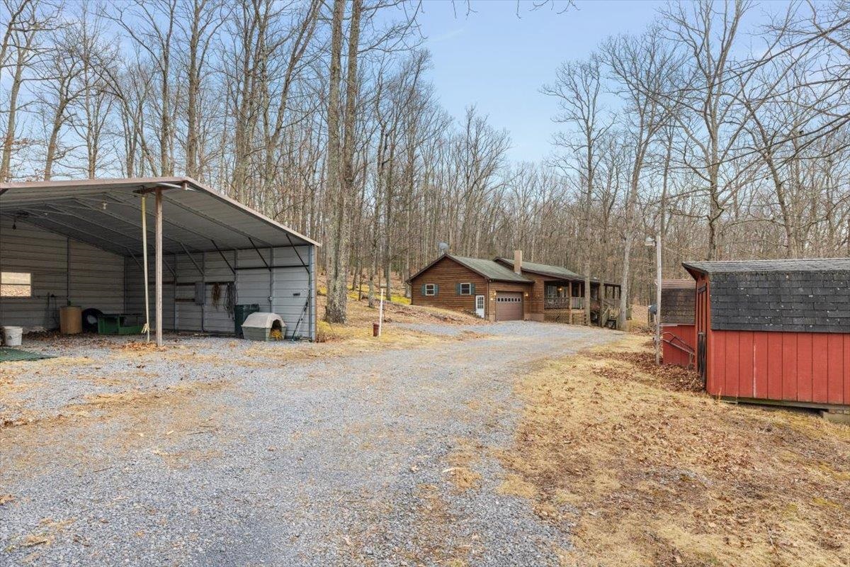 1182 Mullins Road Rio, WV 26755 - Photo 25 of 37 a wooden house with trees in front of it