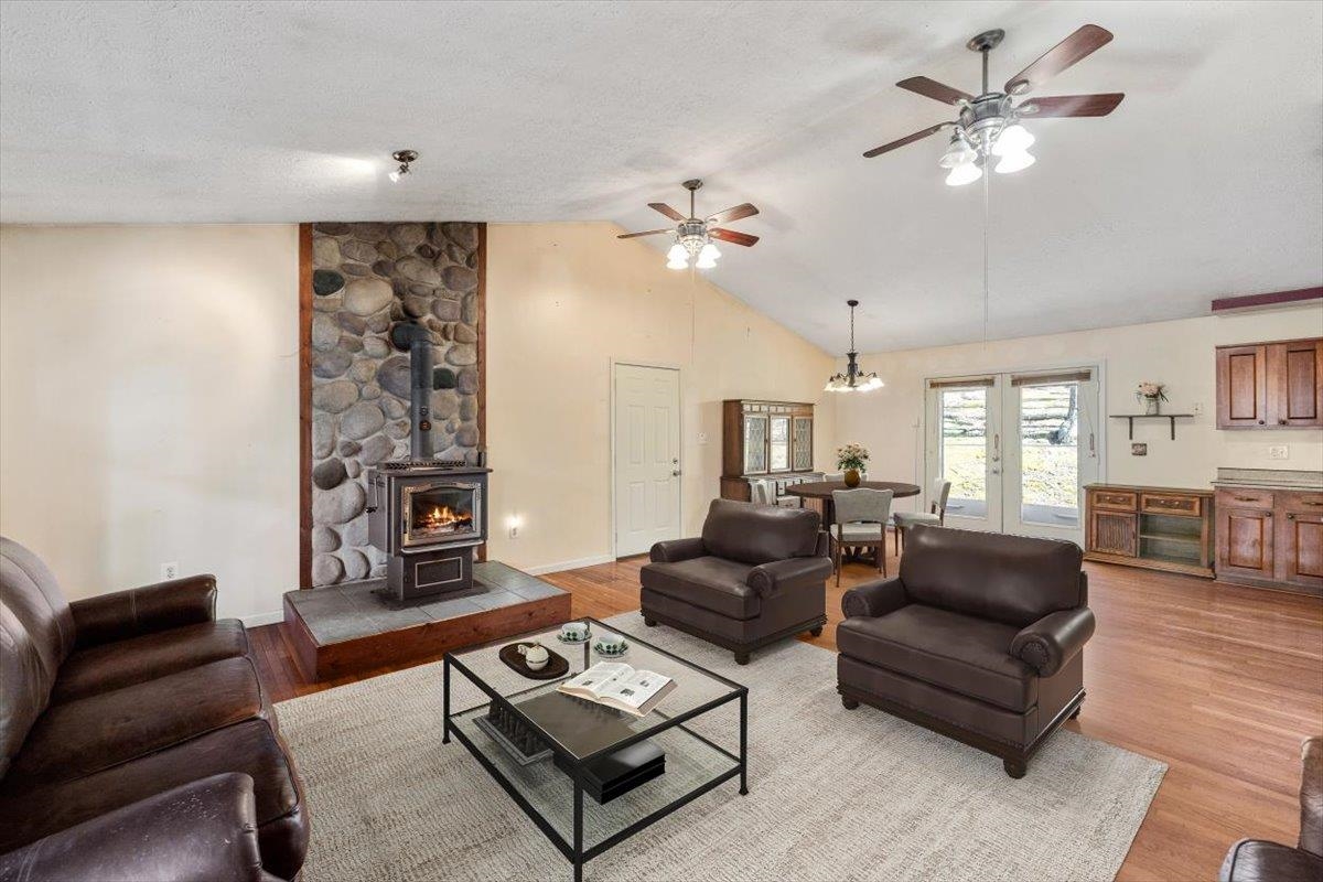 1182 Mullins Road Rio, WV 26755 - Photo 4 of 37 a living room with furniture a fireplace and a chandelier