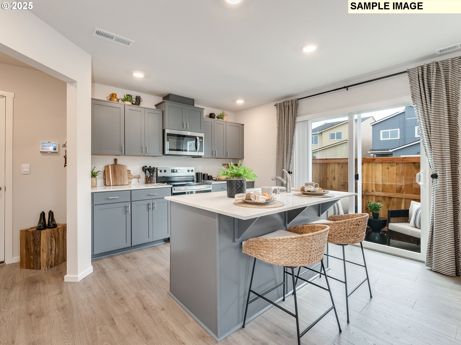 1108 Southeast 194th Place Camas, WA 98607 - Photo 31 of 31 a kitchen with a table chairs refrigerator and a sink